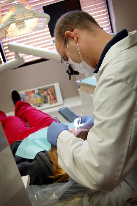 Dr. Matthews examining a patient in the treatment room